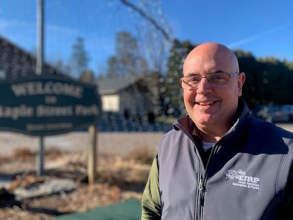 Photo of Mark Brislin in front of the sign at EJRP